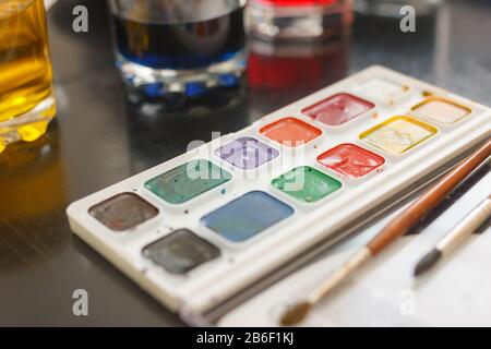 glasses with multicolored coloring water ant paints. close-up. Easter preparations. Stock Photo