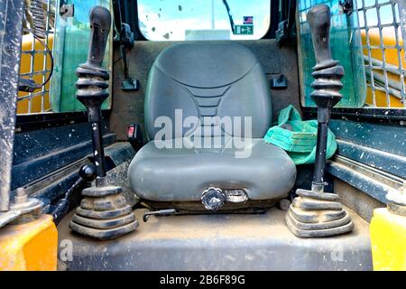 Jockey seat, joysticks, heavy duty mining machinery at a building site. Stock Photo