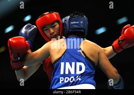 Amman, Jordan. 10th Mar, 2020. Li Qian (L) of China competes with Pooja Rani of India during their Women's Middleweight (69-75kg) semifinal at the Asian/Oceanian Boxing Qualification Tournament for 2020 Tokyo Olympic Games in Amman, Jordan, March 10, 2020. Credit: Mohammad Abu Ghosh/Xinhua/Alamy Live News Stock Photo