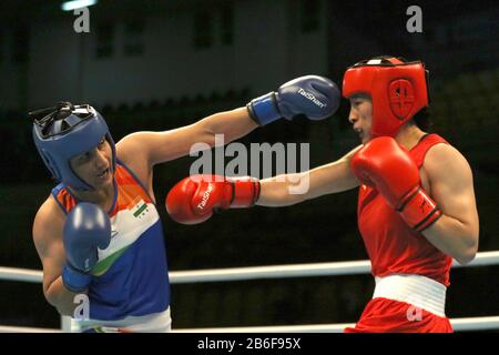 Amman, Jordan. 10th Mar, 2020. Li Qian (R) of China competes with Pooja Rani of India during their Women's Middleweight (69-75kg) semifinal at the Asian/Oceanian Boxing Qualification Tournament for 2020 Tokyo Olympic Games in Amman, Jordan, March 10, 2020. Credit: Mohammad Abu Ghosh/Xinhua/Alamy Live News Stock Photo