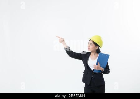 Asian women engineering inspecting and working and holding blueprints and clipboard checking isolated on white background Stock Photo