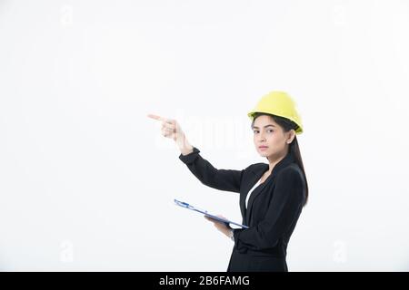 Asian women engineering inspecting and working and holding blueprints and clipboard checking isolated on white background Stock Photo