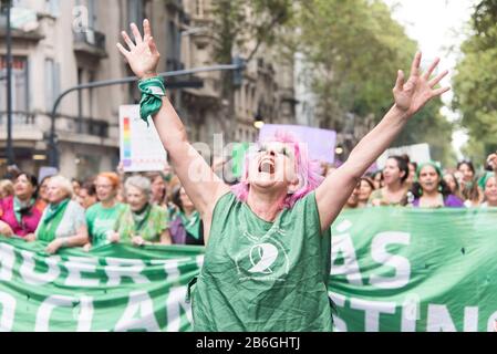 CABA, Buenos Aires / Argentina; March 9, 2020: international women's day. Expressive woman marching in support of the approval of the law of legal, sa