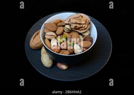 Various nuts on plates, Germany Stock Photo