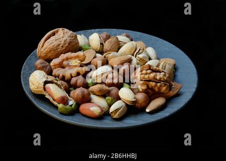 Various nuts on plates, Germany Stock Photo