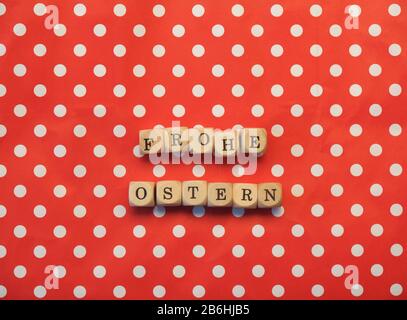 German words Happy Easter on dotted background, red background with white dots, happy holidays concept Stock Photo