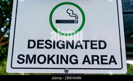 Designated Smoking Area signage with cigarette symbol Stock Photo