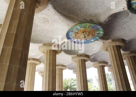 Sun mosaic from broken tiles on the ceiling of Hypostyle Room in Park Guell, Barcelona, Spain Stock Photo