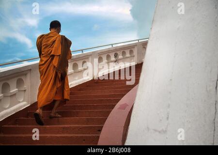 Monks climbing stairs in buddhist temple Stock Photo