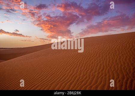 wonderful, dramatic sky over the sandy desert after sunset Stock Photo