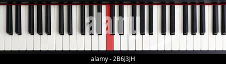 Piano with red key Stock Photo