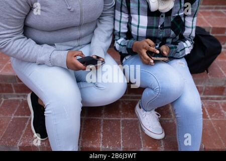 High angle view of students using phones outside Stock Photo