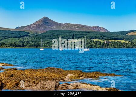 View towards Goat Fell and Brodick Castle across Brodick Bay from Brodick in Arran Argyll & Bute Scotland UK Stock Photo