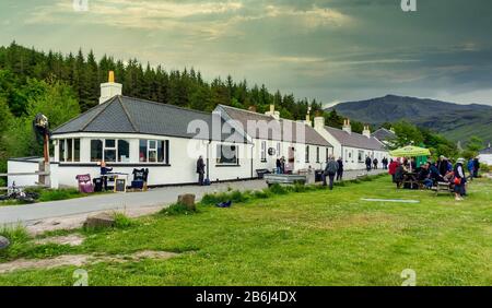 The Old Forge Pub with visitors in the village of Inverie in Inverie Bay Loch Nevis on Knoydart the West Highlands of Scotland Stock Photo