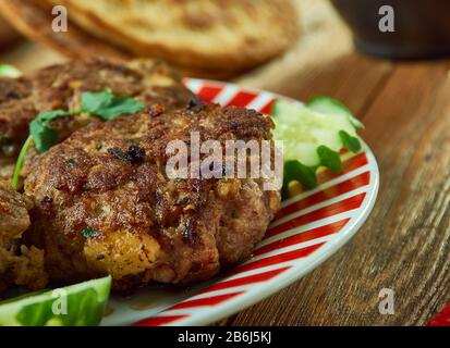 Shami kebab, variety of kebab, originating from the Indian subcontinent,  Awadhi cuisine, Traditional assorted Indian  dishes, Top view. Stock Photo