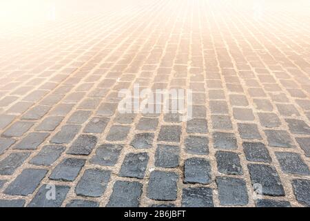 The Granite cobblestoned pavement background. Selective focus Stock Photo