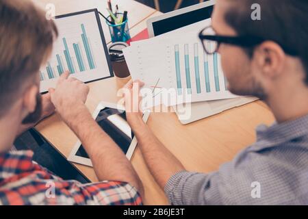Close up of two young managers expertising diagrama of financial growth Stock Photo