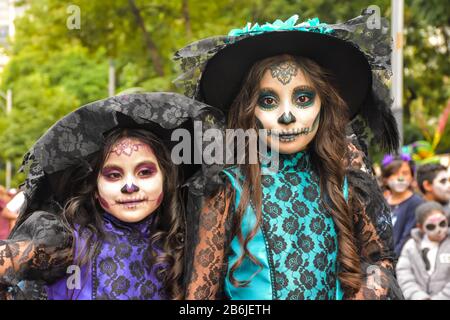 Mexico City, Mexico, ; October 26 2019: Two girls dressed in catrina in the procession of catrinas in mexico city Stock Photo