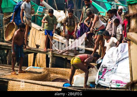 Labors are unloading different types of fish from fishing port. Fish is a great means of fighting food insecurity and climate change in Bangladesh. Stock Photo