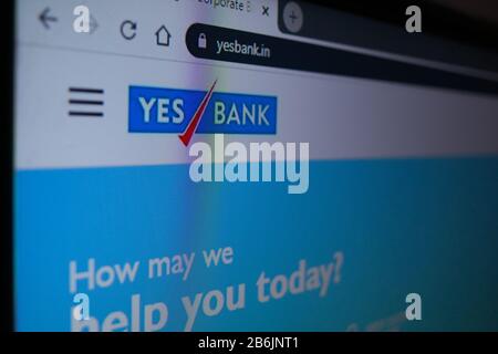 Jaipur, India, Circa 2020 - Photograph of Laptop or Television screen showing the Yes Bank website. The website is has a white background, blue logo. Stock Photo