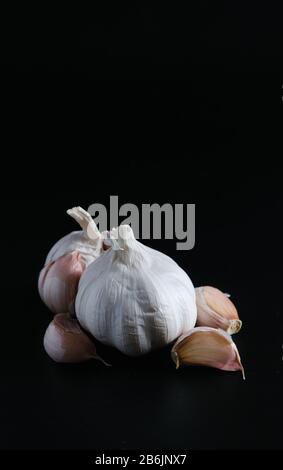 natural food, heads of garlic on a black background Stock Photo