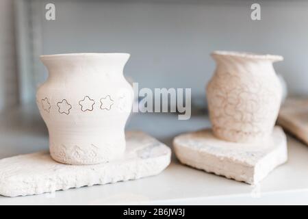 Empty clay pots drying on a shelf Stock Photo