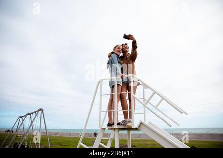 Low angle view of friends taking selfies together Stock Photo