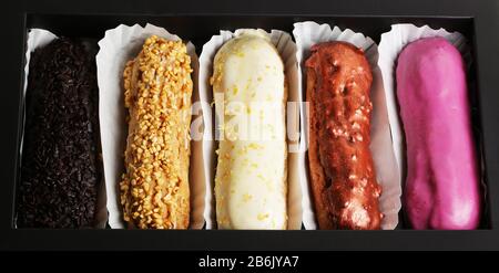 Eclair french cake delicious dessert on black background close up food photo Stock Photo