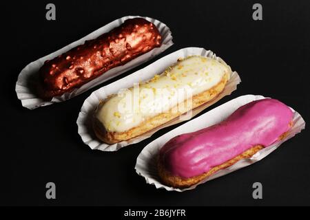 Eclair french cake delicious dessert on black background close up food photo Stock Photo
