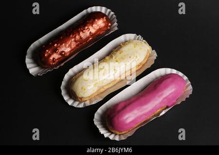 Eclair french cake delicious dessert on black background close up food photo Stock Photo