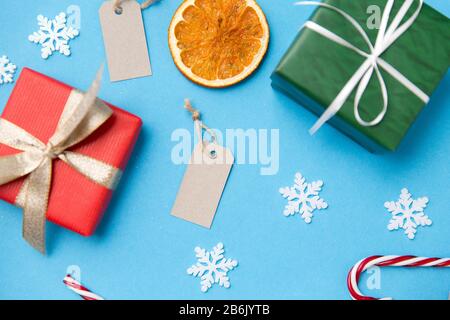 winter holidays, new year and christmas concept - gift boxes, tags and decorations on blue background Stock Photo