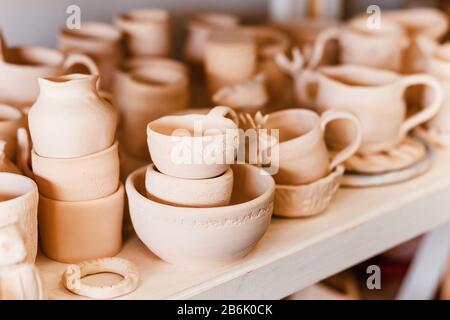 Empty clay pots drying on a shelf Stock Photo