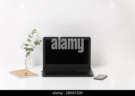 business, electronics and interior concept - laptop with black screen on white office table Stock Photo
