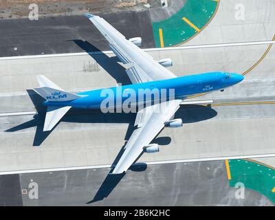 Aerial view of Royal Dutch Airlines Boeing 747 departure from LAX airport. KLM B747 aircraft taking off. Jumbo airplane model being retired by KLM. Stock Photo