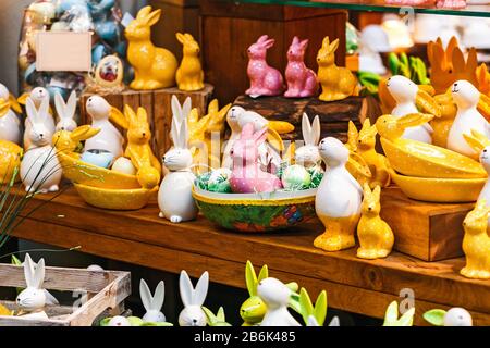 Ceramic toy Easter rabbits on sale at the window of a souvenir shop Stock Photo