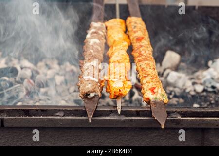 Cooking Kebab on metal skewer barbecue. Traditional Turkish cuisine Stock Photo