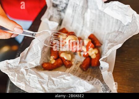 Appetizing grilled sausages with sauce on cafe table Stock Photo