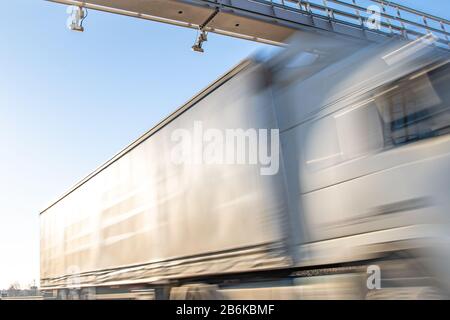 truck passing through a toll gate on a highway toll roads Stock Photo