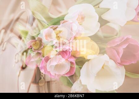 Blurred floral background, double exposure, colorful tulips. Concept of spring, holidays and gifts