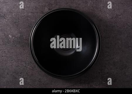 Empty black bowl on black slate background top view Stock Photo