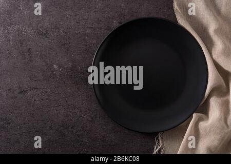 Empty black plate on black slate top view copy space Stock Photo