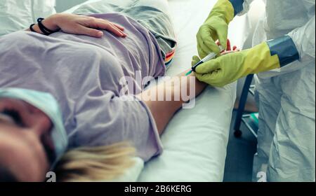 Doctor doing a blood test to a patient Stock Photo