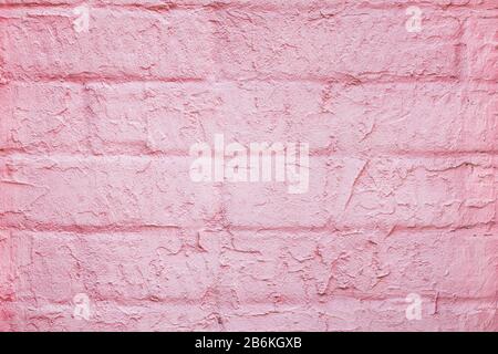 Close up of a pink brick wall covered with decorative stucco. Abstract modern trendy brick texture background Stock Photo