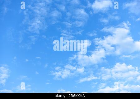 Blue sky with small white fleecy clouds. Natural background Stock Photo