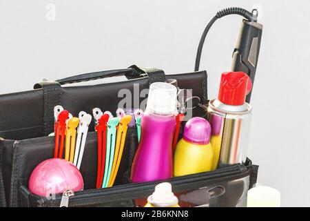 Bag of professional hair stylist with a set of various modern hairdresser tools and products Stock Photo