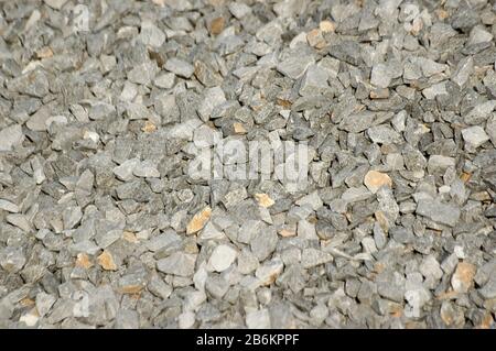Closeup of crushed limestone gravel. Shallow depth of field. Roadways, railroads and construction concepts Stock Photo