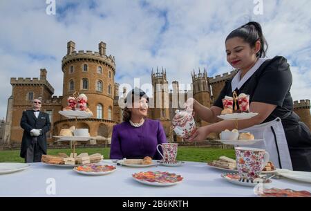 Emma Manner, Duchess of Rutland (centre), is served tea by Lliana Dimitrove, during the launch event for a Royal Afternoon Tea inspired by Netflix's The Crown, at Belvoir Castle, Grantham. Stock Photo