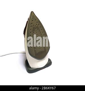 Modern electric iron with many steam holes on work surface stay in vertical position isolated on white background studio shot close up view Stock Photo