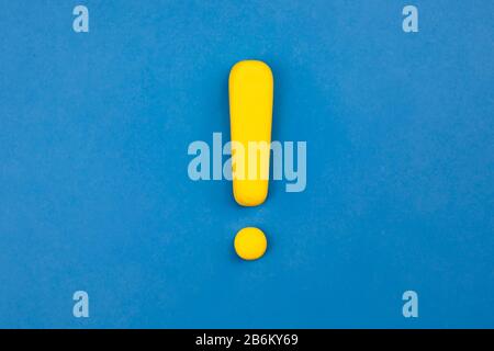 Vivid exclamation mark on blue background. Warning, keep attention concept. Stock Photo