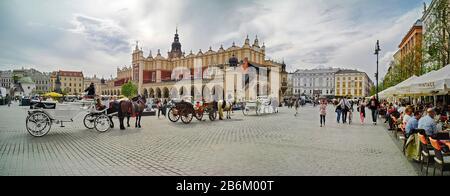 Horse coaches and Cloth Hall at market square, Krakow, Poland Stock Photo